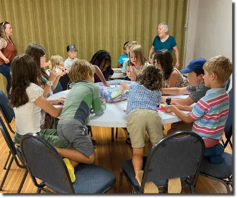 Children at tables working on crafts